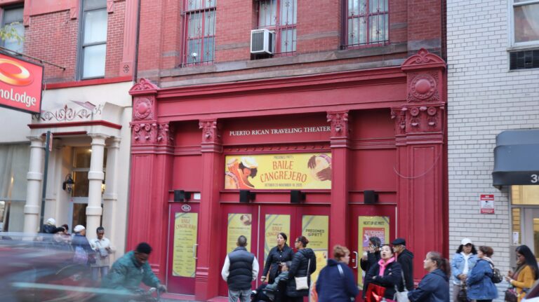 Baile Cangrejero environmental graphics displayed across the Pregones/PRTT facade with event attendees