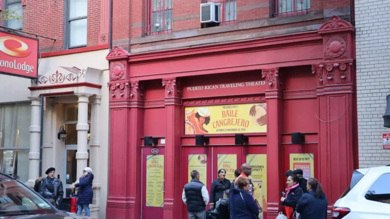 Branded window decals from the Baile Cangrejero campaign, part of the theater print design installed across the Pregones/PRTT storefront.
